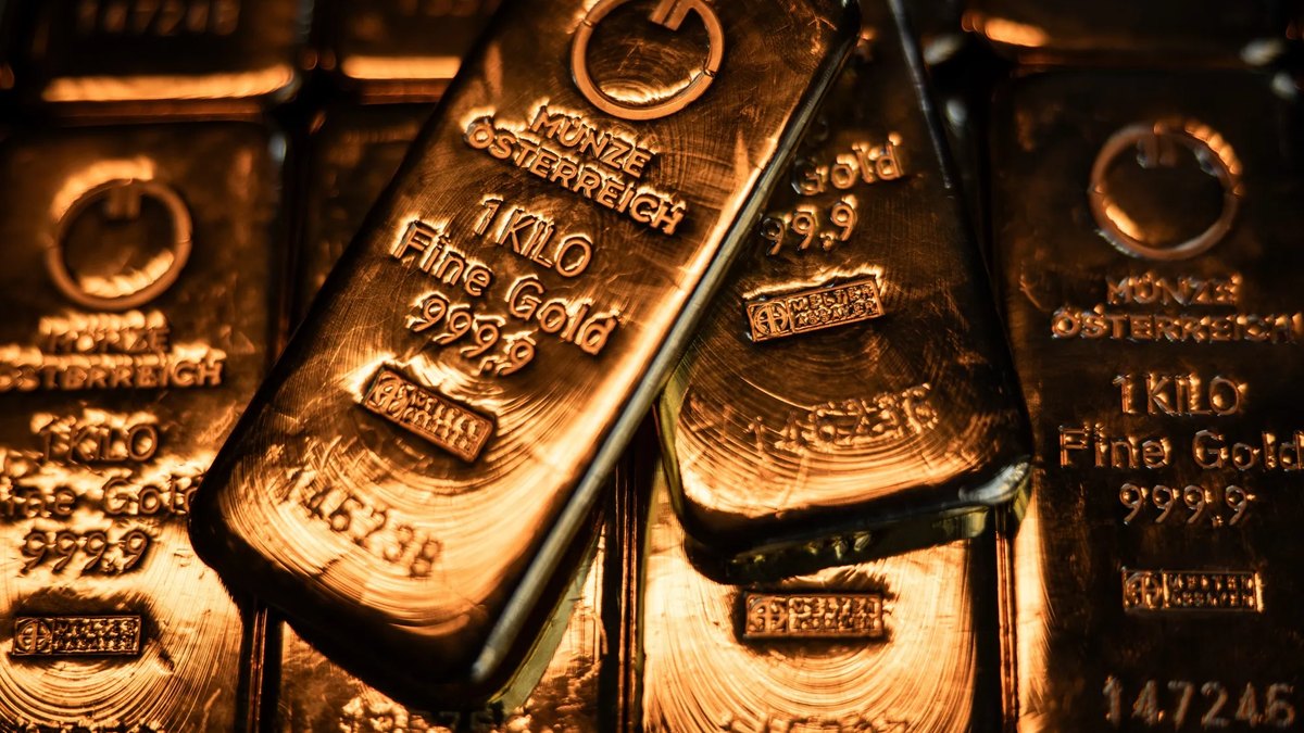 One-kilo fine gold bars stacked under warm light